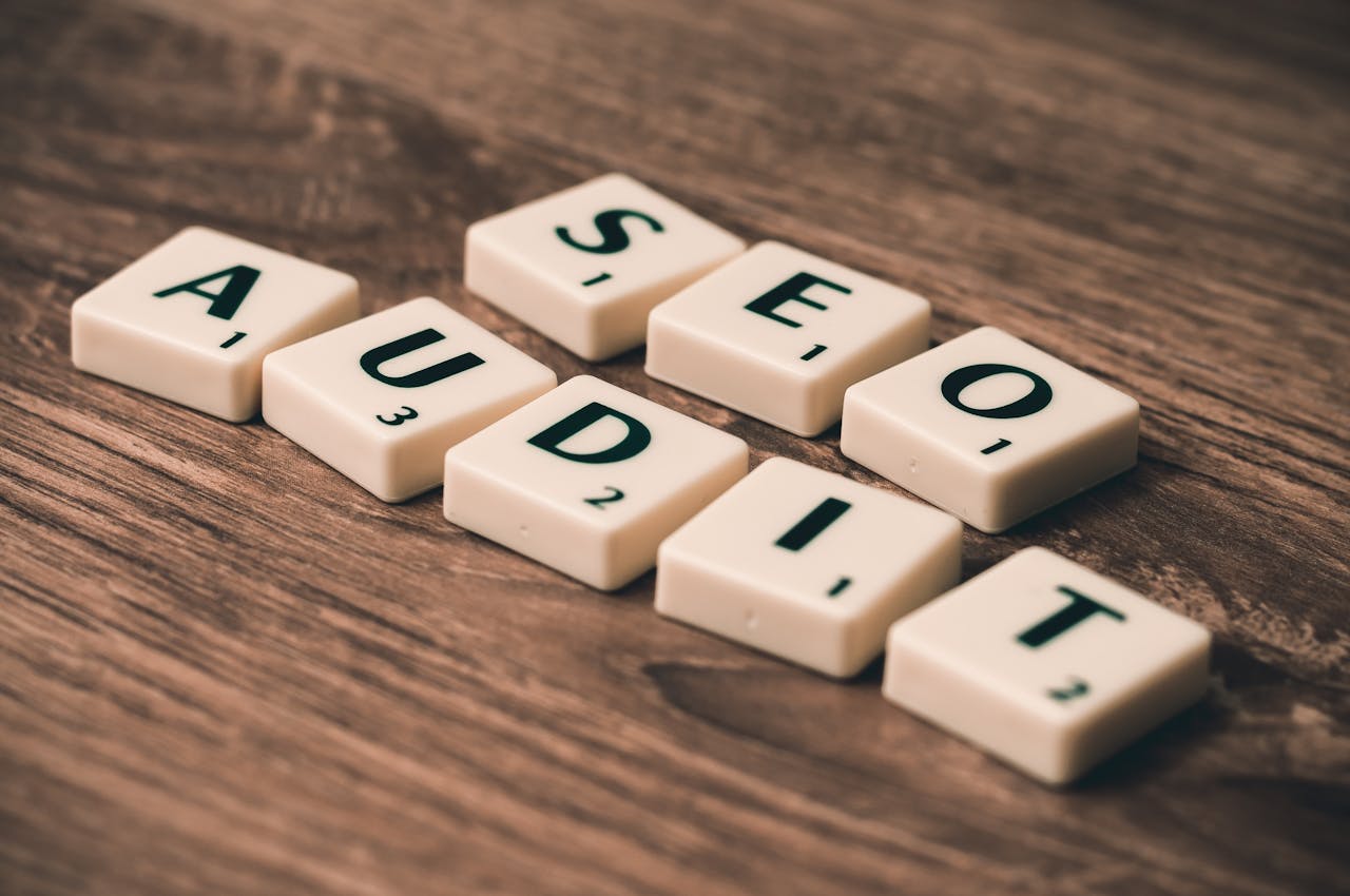 services-03 Scrabble tiles spelling SEO Audit on wooden surface, symbolizing digital marketing strategies.